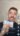 Homme souriant avec des billets en main.